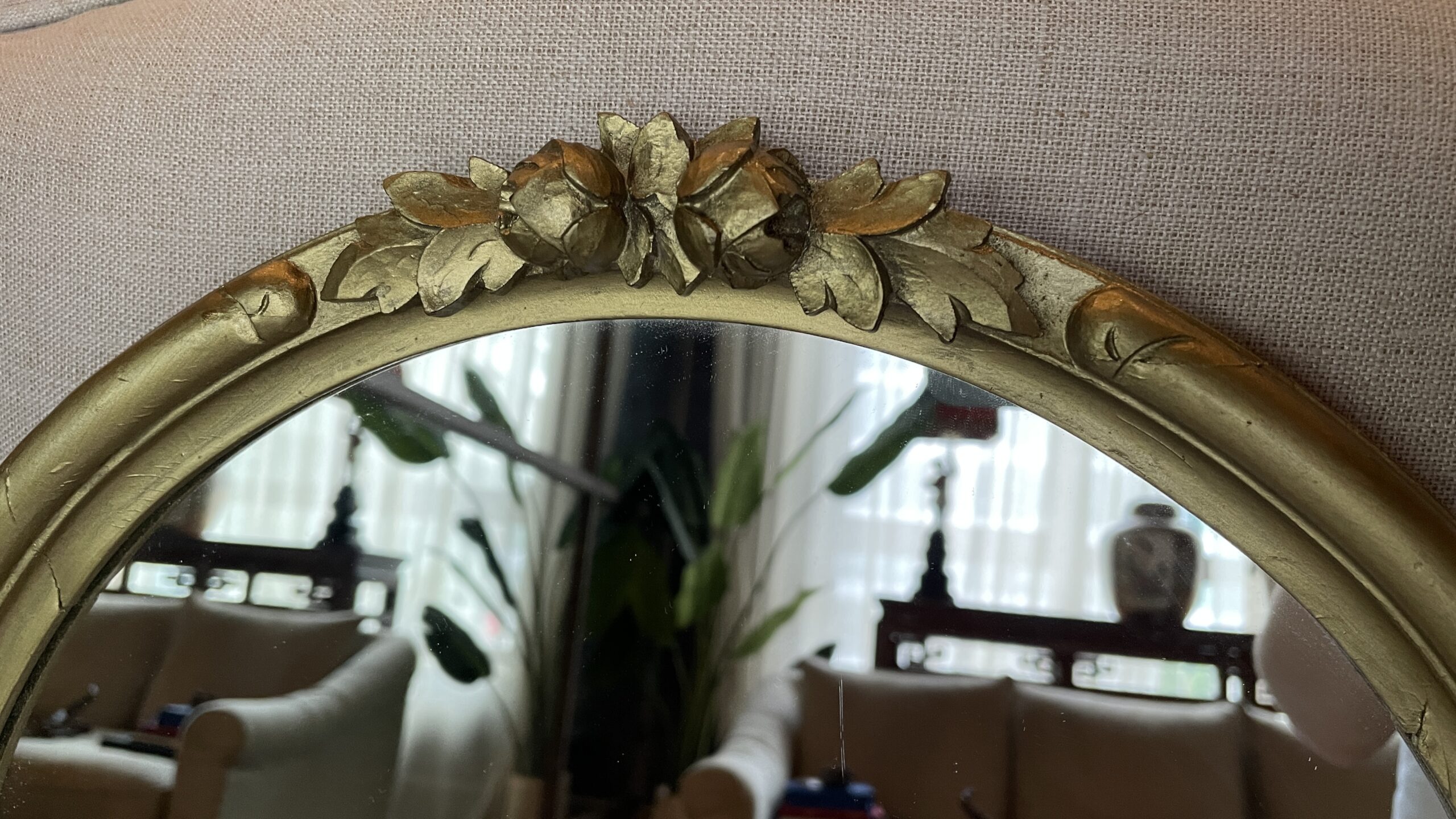 Oval mirror in a carved wooden gold-tone frame-1