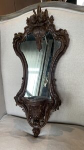 Antique mirror in a carved wooden frame with angels, 1900s