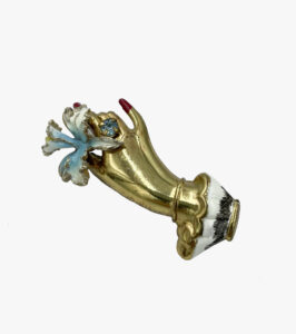 Vintage brooch in the shape of a hand with a flower